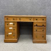 A C.1900 pine twin pedestal desk having a rectangular thumb moulded top over an arrangement of