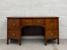 A Georgian mahogany sideboard having a bow fronted top over a single frieze drawer flanked by two