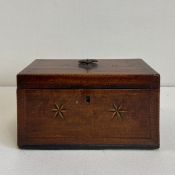 A Georgian mahogany tea caddy having a lockable hinged lid with an ebony and satinwood inlaid edge