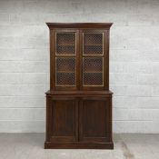 A 19th century pantry cupboard having a moulded cornice above two cabinet doors with brass