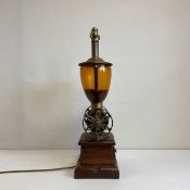 A 20th century ornamental brass mounted coffee grinder table lamp base having a tinted glass bowl