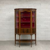 An Edwardian mahogany and satinwood strung display cabinet woth bowed glazed panels on square