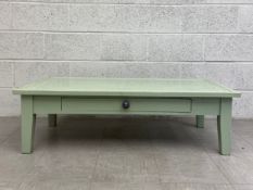 A 20th century painted wooden coffee table having a rectangular moulded top over a single frieze