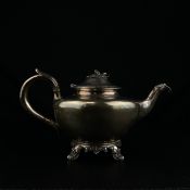 A 19th century English hallmarked silver teapot with leaf and bud finial and squat bulbous body on