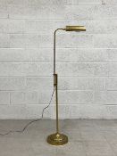 A vintage brass floor standing reading lamp with adjustable arm. H.137cm (fully adjusted)
