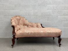 A mid 19th century mahogany framed chaise longue in deep buttoned upholstery. H.92 L.70 D.85cm