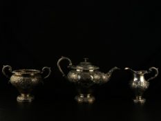 A 19th century Scottish hallmarked silver three piece tea set with all-over scrolling foliate