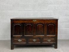 A C.1800 Welsh oak mule chest with plank top, fielded panelled front and three base drawers raised