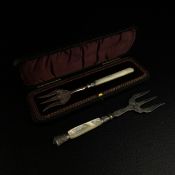 A 19th century cased hallmarked silver pickle fork with a mother of pearl handle along with a