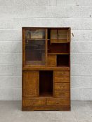 An early 20th century burr elm Cha Tansu or Japanese tea cabinet in two parts, the upper section