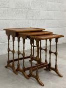 An Edwardian nest of three mahogany side tables each having a square moulded top raised on a