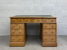 A mid 19th century oak three section pedestal desk with inset gilt and tooled leather top above an