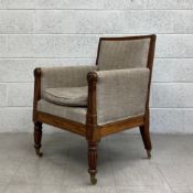 A George IV mahogany bergere style library armchair on tapering reeded supports. H.86cm