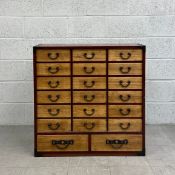 A 20th century Japanese hardwood chest of drawers having a square iron clad frame encasing an