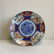 A large Japanese Edo period Imari porcelain charger having a central hand painted cartouche