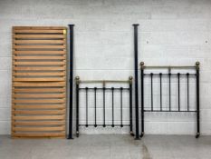 A Victorian bedstead having a brass tubular top rail with two ball finials set onto a cast iron gate