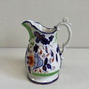 A mid 19th century Gaudy Welsh porcelain flower basket and scroll pattern jug hand decorated with