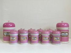 A set of eleven C.1880 York Glass Co. pink glazed stoneware apothecary jars each having a domed