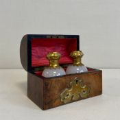A 19th century walnut perfume casket having an openwork brass clad arched top hinged to reveal a