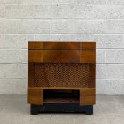 A 1950s radiogram having a cream bakelite Monarch BSR deck and tuner set into an Art Deco style