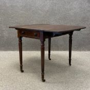 A Regency mahogany drop leaf Pembroke table having a square top with a moulded edge over a single