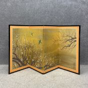 A contemporary folding Japanese low screen having four panels with a continuous hand painted and
