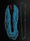 Two necklaces to include one with turquoise cabochons set into a gold plated chain along with