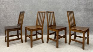 A set of four dining chairs, three Georgian elm with one matched, each having a square slatted