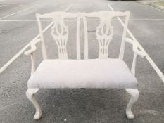A 20th century Chippendale style painted two seater hall bench having a shaped top rail over two
