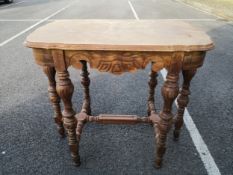 A late 19th century satin walnut occasional or lamp table having a moulded quatrefoil top with a
