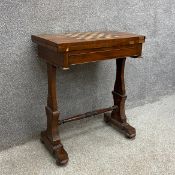 A 19th century mahogany games table having a rectangular top inlaid with an ebony and satinwood