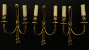 A set of three French 19th century style gilt metal wall sconces each having a flowerhead finial