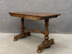 A 19th century Regency rosewood library table having a rectangular book matched top over a carved