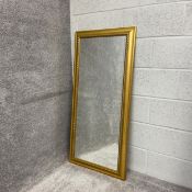 A contemporary wall mirror having a rectangular plate in a moulded giltwood surround. H.123.5 W.58cm