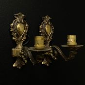 A pair of 19th century style brass wall sconces each having a scrolling foliate back plate with a