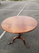 A Georgian mahogany occasional table having a circular top over a turned baluster form stem raised