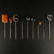 A collection of nine 20th century hat pins set with semi precious stones to include two with white