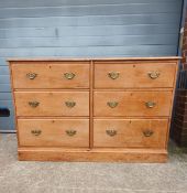 A C.1900 pine chest of drawers having a rectangular thumb moulded top over an arrangement of six
