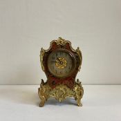 A 20th century gilt metal mounted tortoiseshell French boulle inlaid mantle clock having a shaped