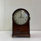 A large early 19th century mahogany mantle or bracket clock having an arched and moulded pediment