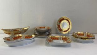 A 19th century porcelain part dinner service with bands of hand painted scrolling gilt foliate
