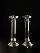 A pair of contemporary crystal candlesticks of square pilaster form in the manner of Waterford -