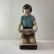 A 20th century painted chalkware figure, kneeling girl with bowl on a plinth base with impressed