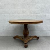 A William IV mahogany dining table having a circular thumb moulded oak top with a crossbanded frieze