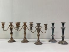 A set of three silver plated triple branch candlelabras and a pair of single candlesticks. H.27cm