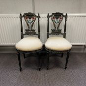 A pair of 20th century carved and painted salon chairs each having a profusely carved top rail and