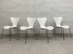 A set of four contemporary Series 7 white bent plywood dining chairs C.2000 raised on splayed