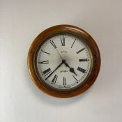 A 20th century Smiths London wall clock having a circular hand painted dial bearing Roman numerals