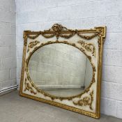 A large late 19th century French giltwood overmantel mirror having a ribbon cresting on a carved egg