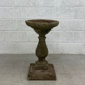 An early 20th century carved stone birdbath in three parts having a wide circular bowl resting on
